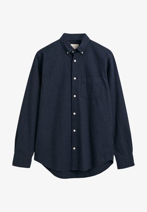 Camicia blu navy, con bottoni e realizzata in tessuto texturizzato. Caratterizzata da un colletto, maniche lunghe e una singola tasca sul petto. Design con orlo dritto.