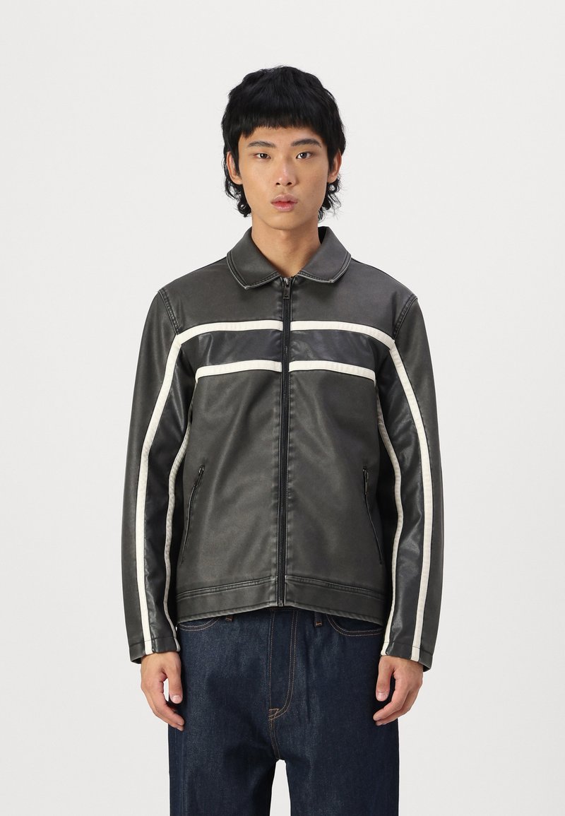 Black faux leather jacket with a zip front, white stripes across the chest and sleeves, and side pockets. Smooth texture, collared design.