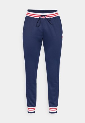 Pantalones deportivos azul marino con cintura a rayas rojas y blancas, cierre con cordón, piernas ajustadas, bolsillos laterales y pequeño detalle de logo en el muslo.