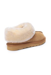 Tan suede slipper with a plush, cream-colored shearling cuff. Features a solid rubber sole for grip and durability.
