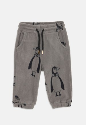 Gray fleece pajama pants featuring a penguin pattern, elastic waistband with drawstring, and side pockets. Cuffed at the ankle.