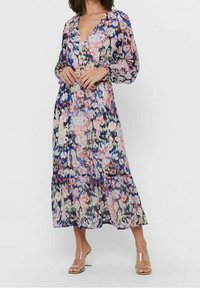 Long, floral print dress featuring a V-neckline, puffed sleeves, and a tiered hem. The fabric is lightweight with a colorful abstract pattern.