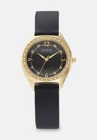 Gold-tone watch with a black face and crystal accents. Features a round case and black silicone strap, displaying numbers 1 to 12.