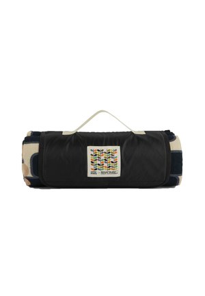 Rolled patterned outdoor picnic blanket secured with a black carrying strap featuring a handle and a colorful leaf logo patch.
