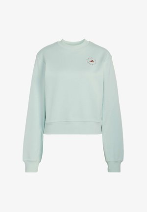 Light blue cropped sweatshirt with long sleeves and round neck, featuring small circular logo with text on upper left chest.