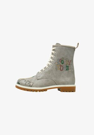 Gray suede boot with white laces and Looney Tunes graphic design. Features a rounded toe and gum rubber sole with ridged pattern.