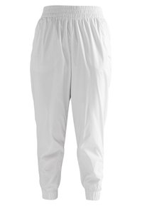 Bílé teplákové kalhoty z lehké látky s elastickým pasem a lemy, bočními kapsami a jednoduchým designem.
