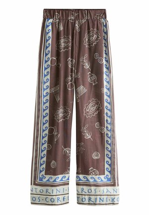 Brown wide-leg pants with blue wave borders, white abstract sketches, and Greek island names printed along the hems.