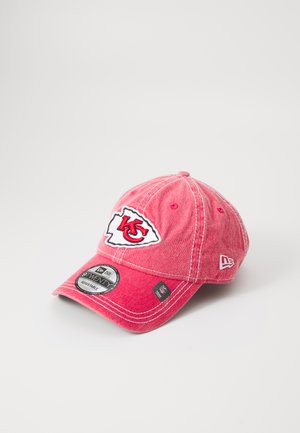 Red baseball cap made of cotton, featuring an embroidered logo on the front, contrasting white stitching, and an adjustable back strap.