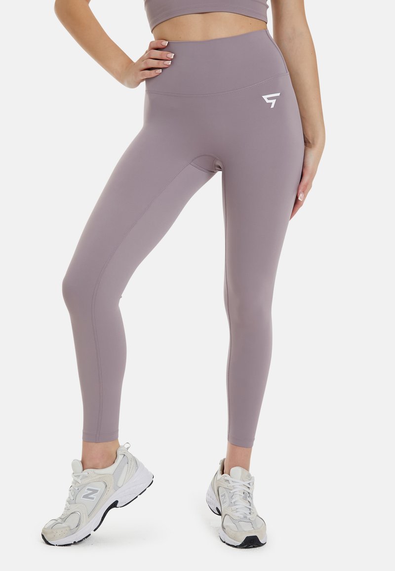 Højtaljede, tætsiddende leggings i dæmpet lavendel, lavet af strækbart stof med diskrete sømdetaljer og et hvidt logo på hoften.