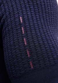 Marineblauer, strukturierter Stoff mit gewebtem Muster. Verfügt über kontrastierende, hellrosa dekorative Nähte entlang der Seite.