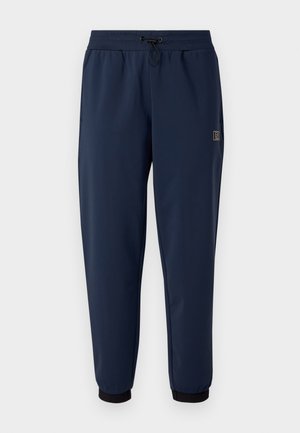 Navy modré sportovní kalhoty vyrobené z lehkého materiálu, s nastavitelným stahovacím pasem a černými řasenými manžetami na kotnících.