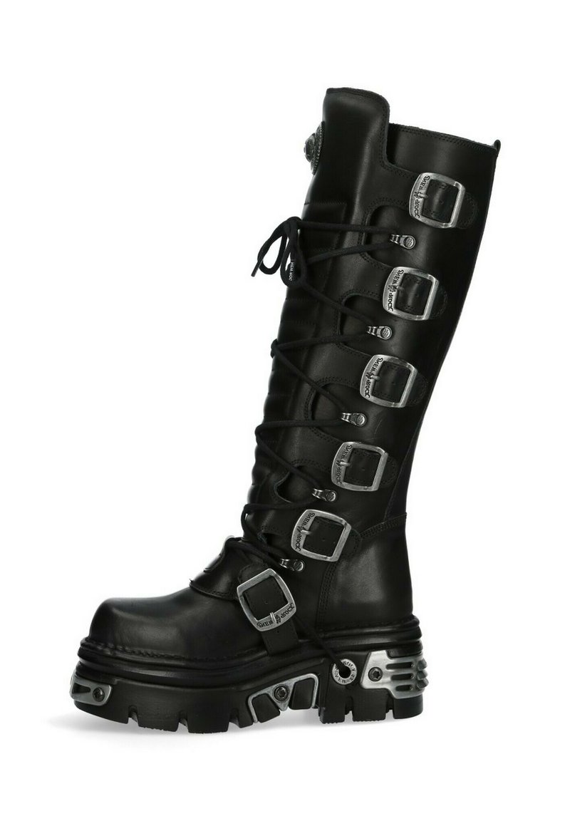 Black knee-high boot with multiple silver buckles, textured leather, lace-up front, rounded toe, and thick, rugged sole.