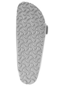 Suola di scarpa in gomma bianca con un motivo a onda, caratterizzata da testo in rilievo e una forma arrotondata. Texture liscia e leggera curvatura.