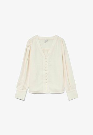 Kreemikas blouse V-kaeluse, pikkade puffse varrukate ja ridade väikeste nuppudega ees. Pehme, tekstureeritud kangas.