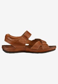 Brown leather sandals with Velcro straps, open design, stitched detailing, and a flat, textured sole.
