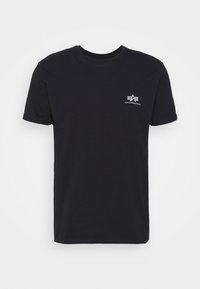 Camiseta de algodón negra con mangas cortas, escote redondo y un pequeño logo blanco con letras estilizadas en el lado izquierdo del pecho.