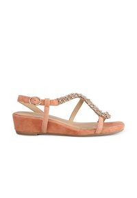 Peach suede wedge sandal with a decorative rhinestone accent on the strap, featuring adjustable ankle buckle and open toe design.