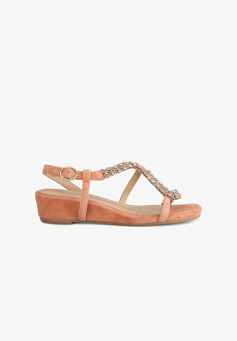 Peach suede wedge sandal with a decorative rhinestone accent on the strap, featuring adjustable ankle buckle and open toe design.