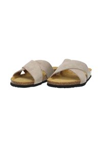 Beige cross-strap sandals made of soft suede, featuring a cork footbed and a textured black rubber outsole for durability.