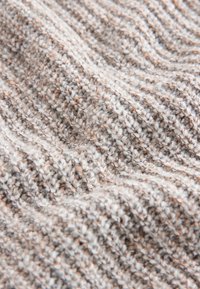Struktureret strikket stof i nuancer af grå og beige, med et bølget mønster og en blød, let fluffy tekstur med varieret trådtæthed.