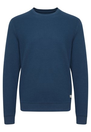 Mørkeblå sweatshirt i teksturert stoff, rund hals, lange ermer og ribbestrikkede mansjetter og nederkant. Liten logo-lapp nederst til venstre.