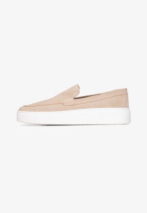 Beige suede slip-on shoe with a rounded toe, featuring a white platform sole and subtle stitching details along the upper.