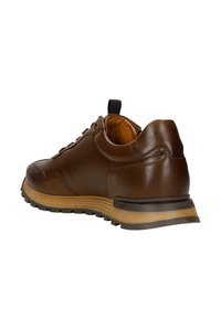Brown leather sneaker with a textured surface, cushioned tan sole, and black rubber traction bottom, featuring eyelets and a pull tab.