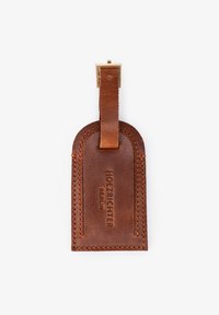 Brown leather luggage tag with a smooth texture and rounded top. Features engraved brand name "HOLZRICHARD BERLIN" and a metal clip.
