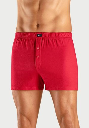 Rote Baumwollboxershorts mit einem bequemen elastischen Bund, Knopfleiste und einer glatten Textur. Schlichtes Design ohne Muster.