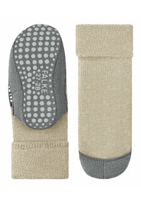 Calze a maglia beige con suola grigia texture dotata di puntini antiscivolo, bordino a costine e punta rinforzata. Logo del marchio visibile di lato.