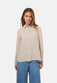 Lichtbeige lange mouwen shirt met een kraag, knopen aan de voorkant en een enkele borstzak. Linnen stof met een licht gestructureerd oppervlak.