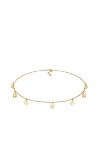 Guld-tone choker med en delikat kæde, der har fem små smiley ansigt charms jævnt fordelt langs længden. Justerbar lås.