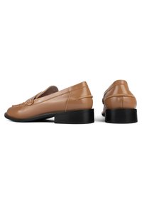 Brown gloss leather loafers with a low black heel, featuring a woven detail on the front and smooth, streamlined design.