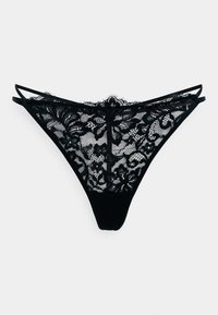 String en dentelle noire avec motif floral, présentant une devant en transparence, un dos uni et des bretelles fines et ajustables. Texture lisse avec des détails élaborés.