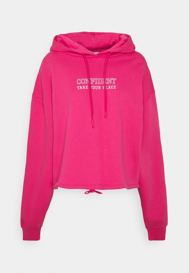 Felpa cropped rosa con coulisse, con una scritta bianca stampata "CONFIDENT TAKE YOUR PLACE" sul davanti. Materiale morbido e vestibilità rilassata.
