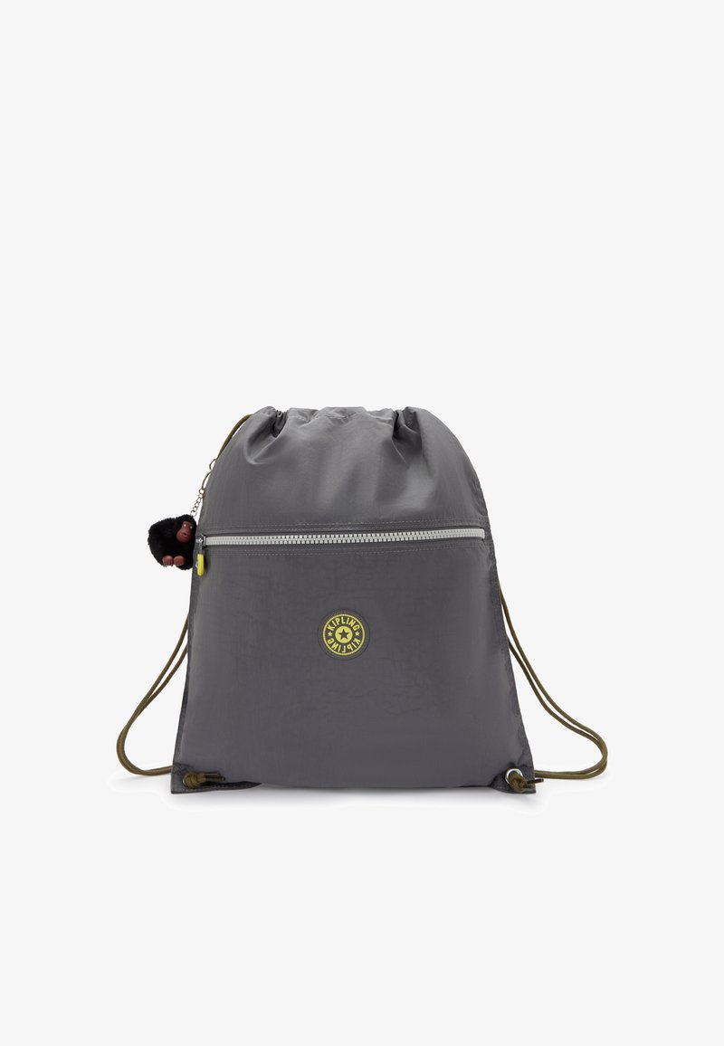 Drawstring bag in gray fabric with smooth texture. Features a front zip pocket, a logo badge, and a decorative monkey keychain.