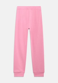 Ροζ παντελόνι φόρμας με ελαστική μέση, στενούς καρπούς και απαλή υφή. Χωρίς ορατά σχέδια ή μεταλλικά στοιχεία.