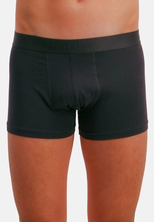 Shorts boxer noirs en tissu extensible, dotés d'une ceinture large avec un logo discret et d'une coupe ajustée.