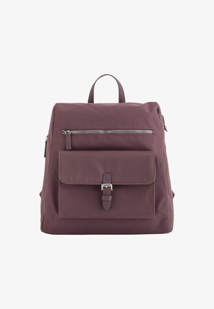 Mochila de color malva oscuro con un acabado de tela suave, bolsillo frontal con cremallera y una solapa delantera asegurada por un cierre metálico. Duales asas superiores.