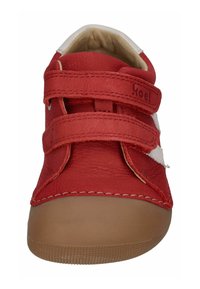 Red leather shoe with two Velcro straps, tan rubber sole, and white accents. Features stitched edges and a rounded toe.