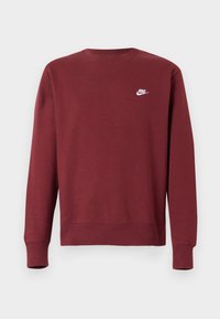 Bordo mikina vyrobená z bavlneného zmesi, má dlhé rukávy, okrúhly výstrih, rebrované manžety a malú bielu Nike logo na hrudi.