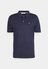 Navy blue polo shirt made of cotton, featuring a classic collar, three buttons, and a small white logo on the chest. Short sleeves.