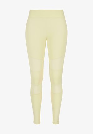 Leggings in lichtgeel. Gemaakt van een gladde, rekbare stof met een hoge taille, featuring paneeldetails langs de benen en een aansluitend ontwerp.