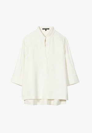 White long-sleeve blouse with mandarin collar, hidden front placket, and slightly longer back hem, designed for women.