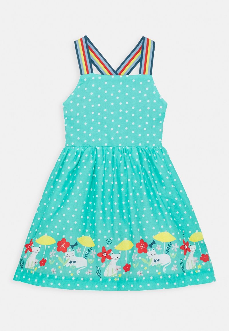 Robe turquoise à pois avec bretelles arc-en-ciel et ourlet décoré de chats blancs, champignons jaunes, fleurs rouges et roses.