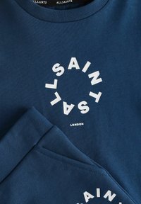Tamno plavi dukserica od pamuka, sa kružnim bijelim logom na dnu sa natpisom "ALLSAINTS LONDON". Tekstura tkanine, okrugli izrez.