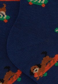 Navy socks featuring playful knitted patterns of brown dogs on green and orange accents, crafted from soft, stretchy material.