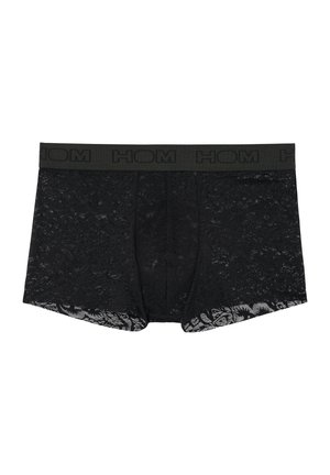 Schwarze Spitzenboxer mit einem festen schwarzen elastischen Bund. Detaillierte Spitzenstruktur bedeckt den Stoff und zeigt ein Blumenmuster an den Beinöffnungen.