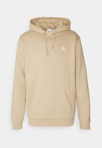 Béžová mikina Adidas s přední kapsou, kapucí na stahování, žebrovanými manžetami a malým bílým logem Adidas na levé hrudi.